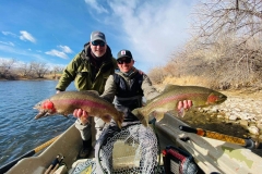 men on boat showing of trout
