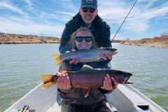 people on boat holding fish