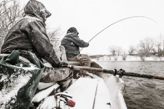 fishermen on a boat fly fishing
